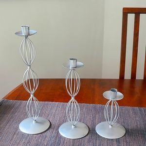 Three piece candle holders. Aluminum, never used, in the box.